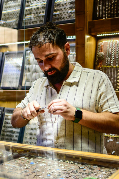 Jeweler examining real gold vs gold palted jewelry