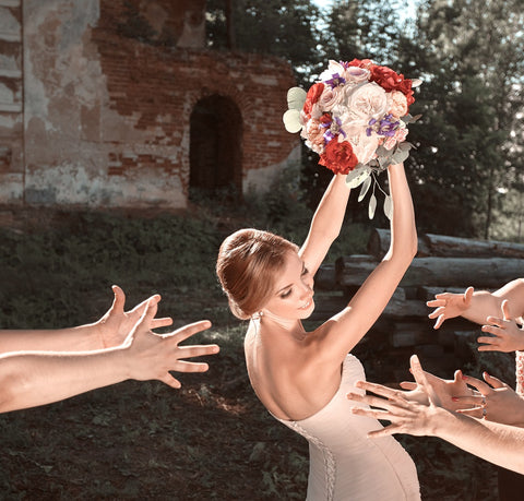 Bride getting ready to toss her bridal bouquet to other women