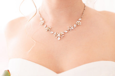 Bride wearing a necklace that  matches her neckline