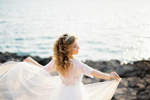 Bride wearing a wedding dress with an outstretched overskirt