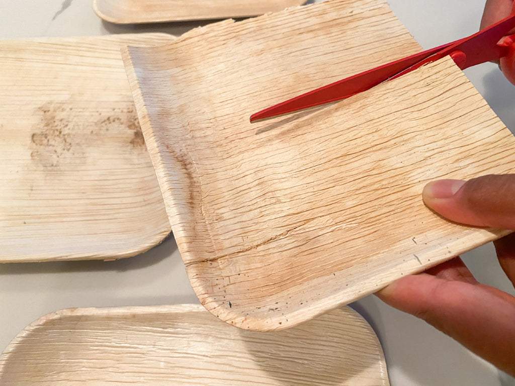 cutting a palm leaf plate