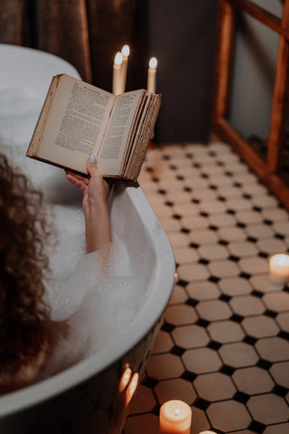 person reading a book in a bath