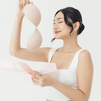 Woman holding one of BOOMBA's sticky bras