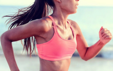 Woman running in a pink sports bra