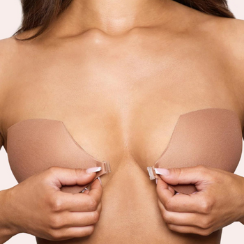 Model putting on a sticky bra, inserts seamlessly under clothing