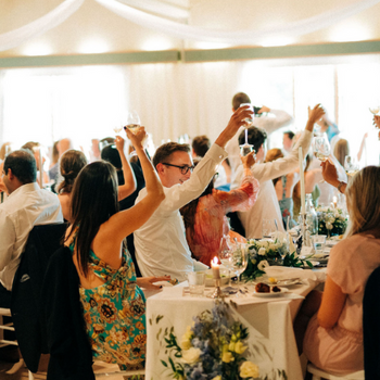 Guests toasting to a wedding speech