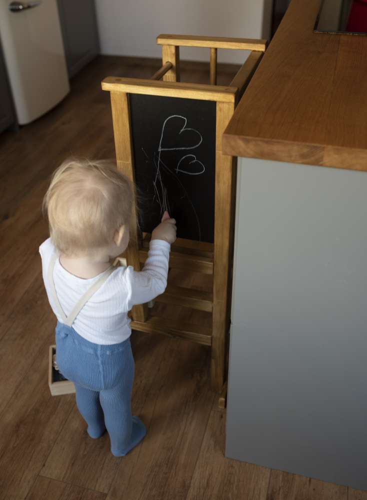 Magnetic built-in chalkboard into a learning tower