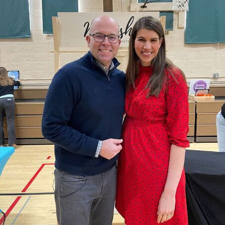 Jamie wearing a red dress standing next to Brian from Fox 6 News