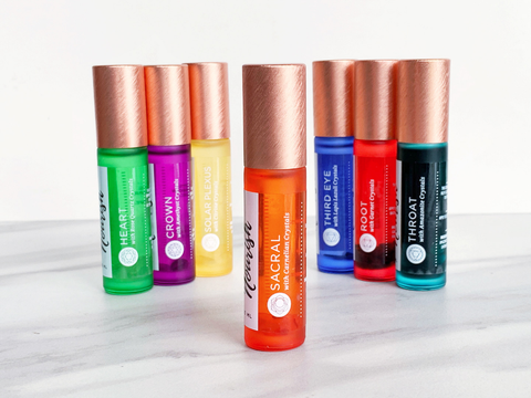 All chakras roller blends standing in an arc with the sacral chakra roller blend in the center front.