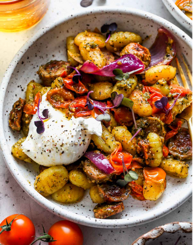 a bowl with gnocci and burrata cheese in it