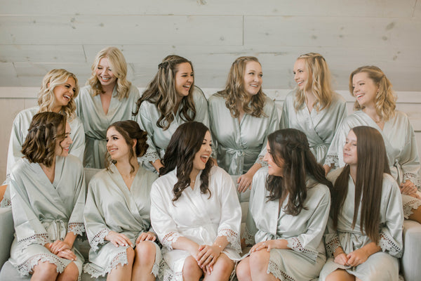 Bride and Bridesmaids gathered together and wearing Kennedy Blue Satin and Lace robes