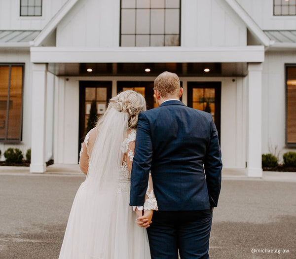 Bride and Groom holding hands outside their wedding venue