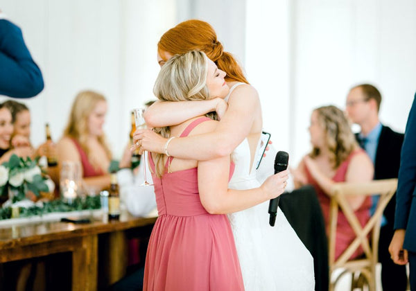 Bridesmaid Hugging Bride