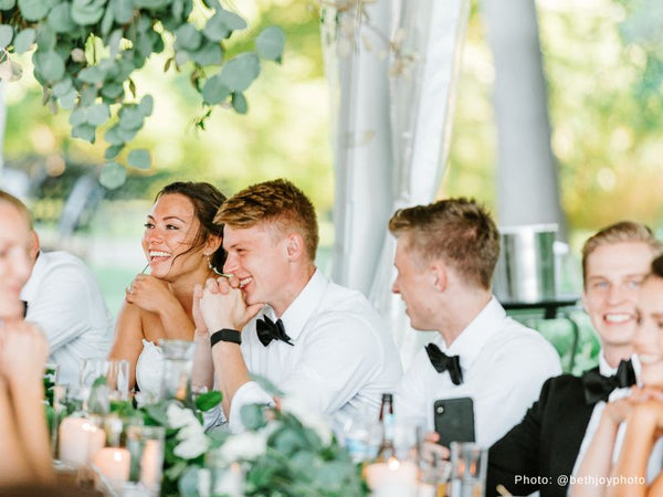 Bride and Groom Reacting to Wedding Speeches