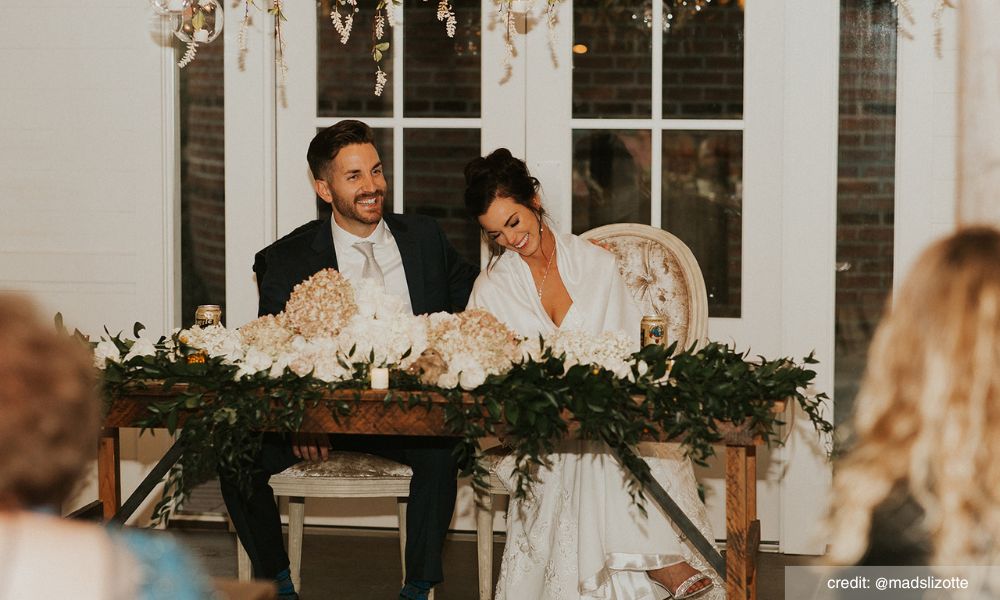 Couple laughing at their wedding table