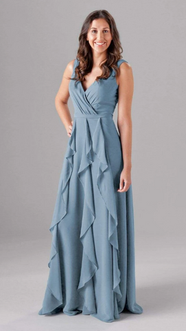 Kennedy Blue model wearing a lovely dress with cascading ruffles and a flowy skirt. 