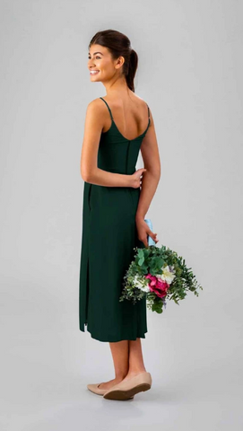 Kennedy Blue model wearing an elegant knee-length dress with cowl neckline and side slit.