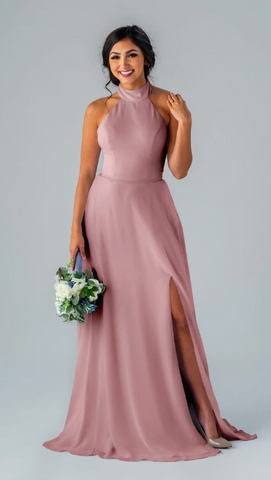 Kennedy Blue model wearing an elegant gown with a high neck and A-line skirt with a side slit.