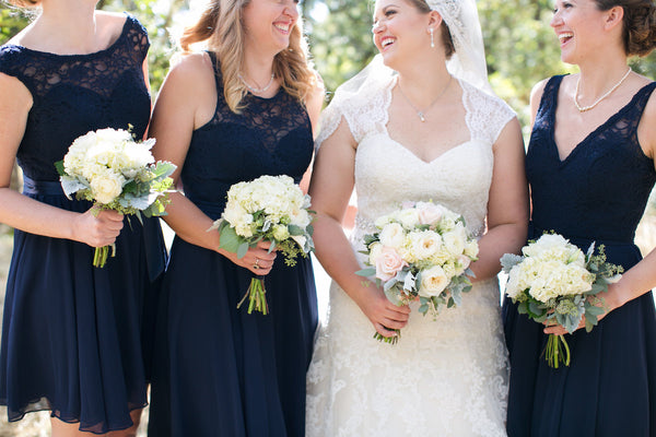 Chic lace-top bridesmaid dresses at a gorgeous outdoor wedding ceremony.