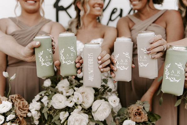Bride and Bridesmaids dressed up and holding customized wedding koozies.