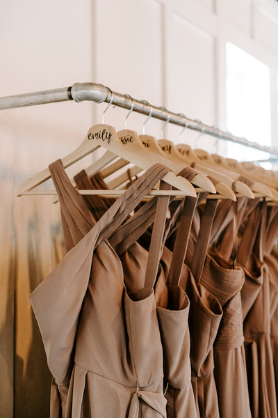 Kennedy Blue Bridesmaid Dresses style "Elena" in 'Fawn' hung up on personalized wooden hangers. 