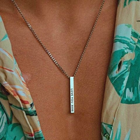 man wearing silver monogrammed necklace - OurCoordinates