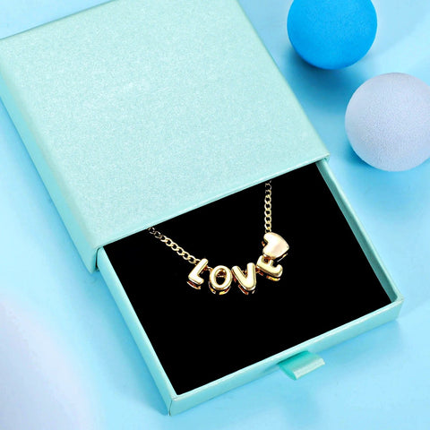 gold 3d bubble letter necklace that spells LOVE with a small heart charm, valentines day gift