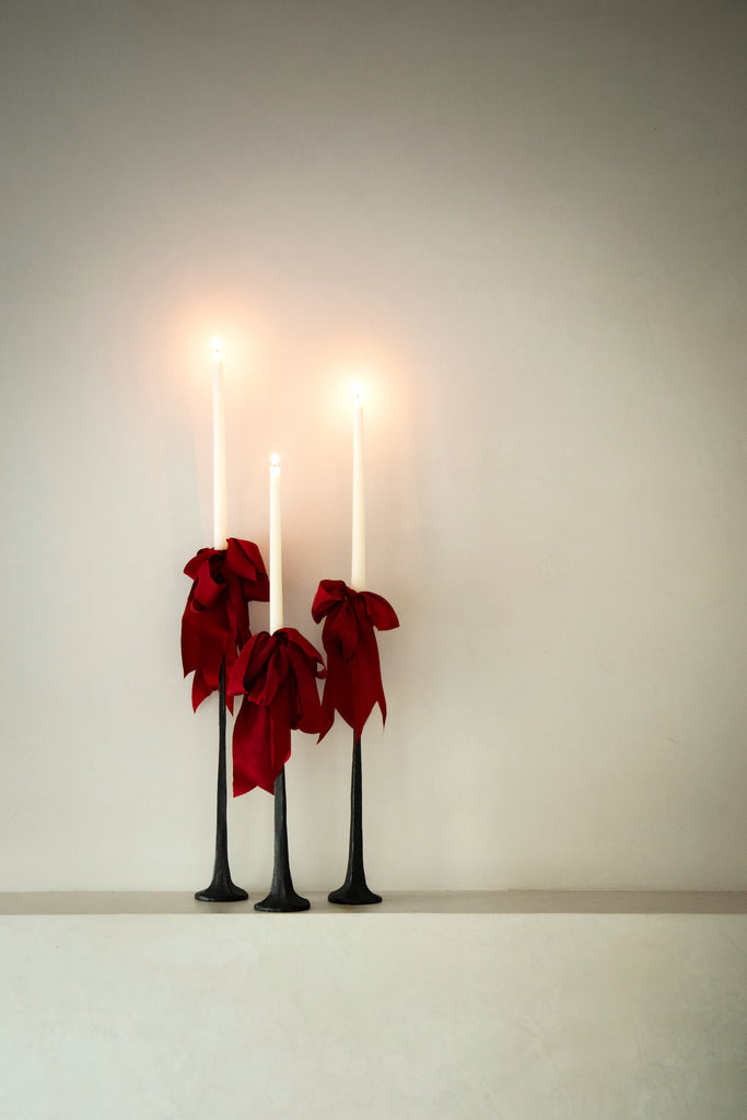 bow stacking trens with red ribbons on candles