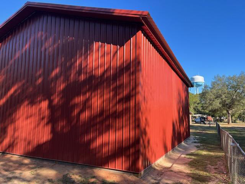 BLACKWATER TRUSS POLE BARN WITH RED METAL PANELS