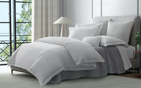 Bed with white sheets and fluffy duvet