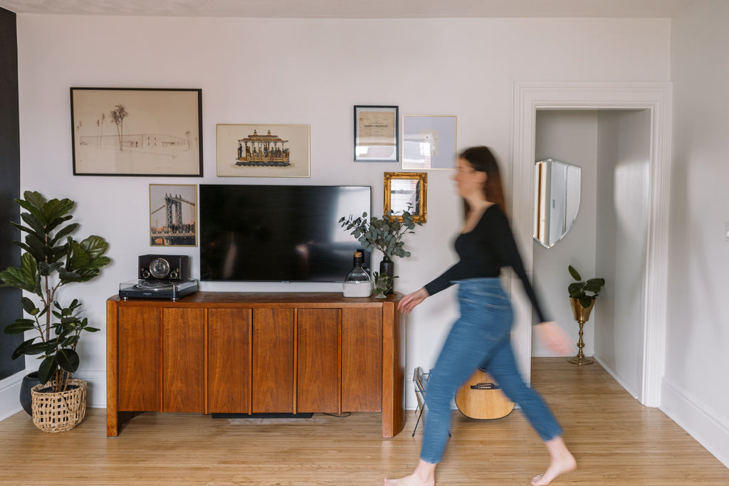 Female walking past livingroom media wall