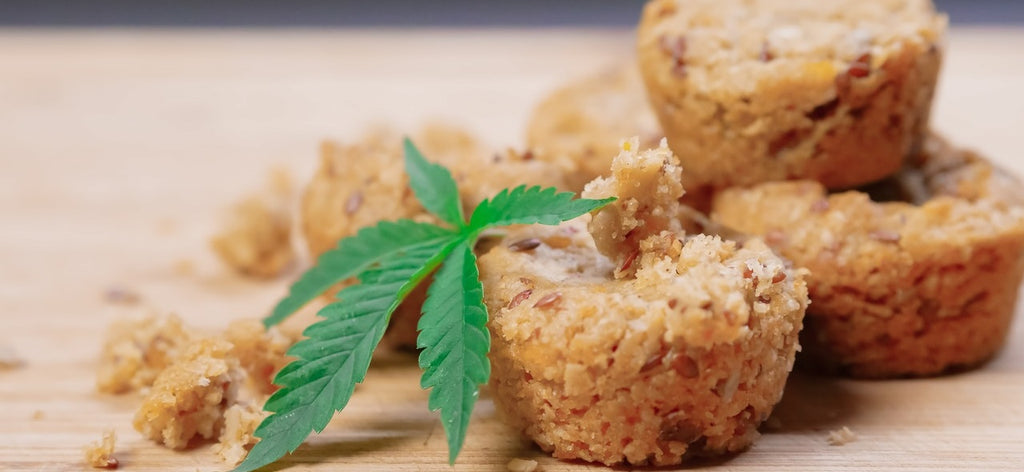 Some cannabis edibles, with a marijuana leaf beside them.