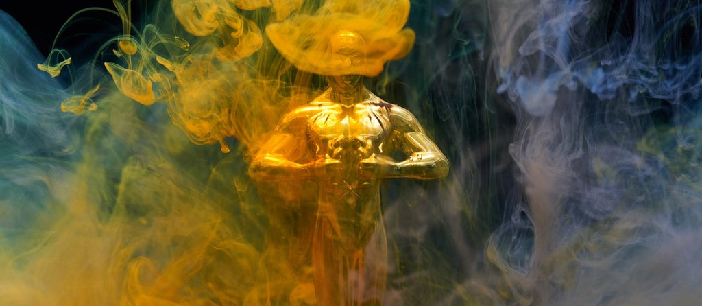 An oscar award statue surrounded by vapor.