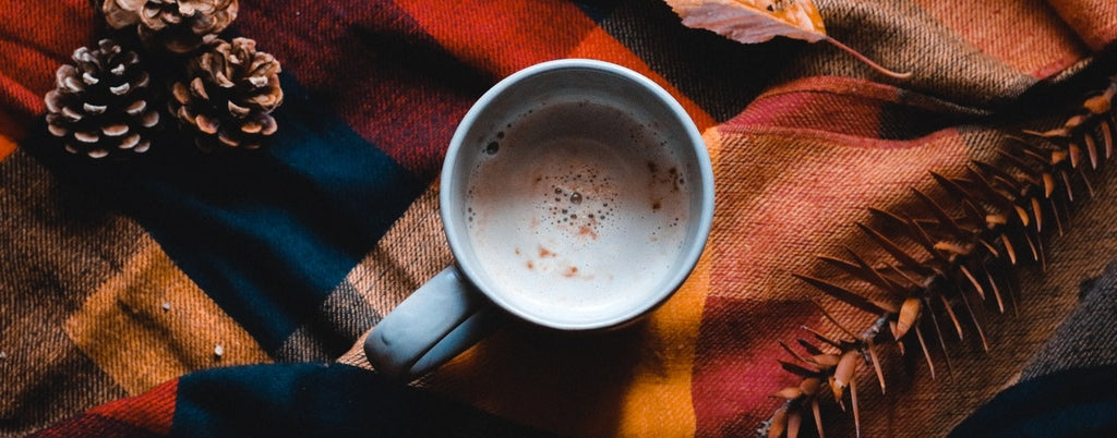 A mug of hot chocolate on a blanket.