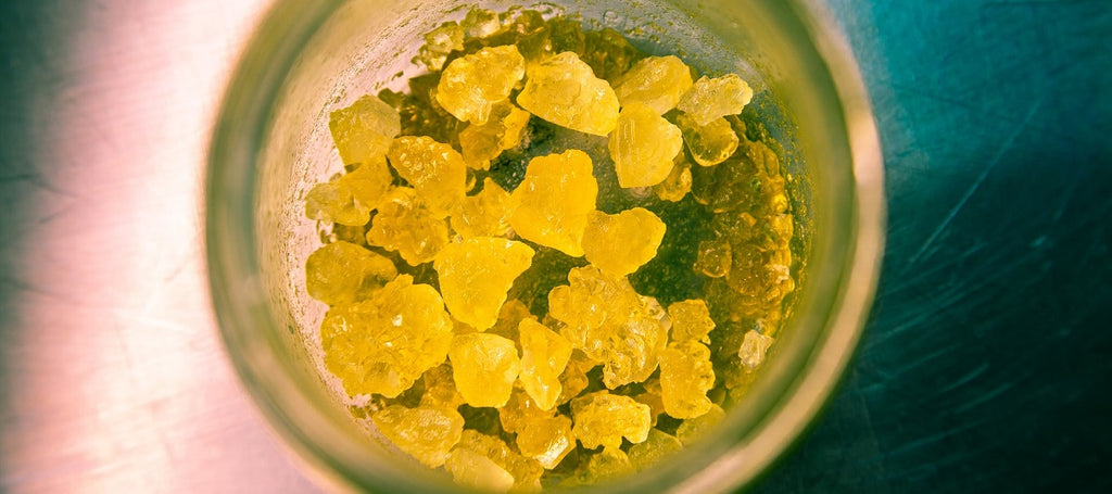 Bright yellow marijuana concentrate in a jar.