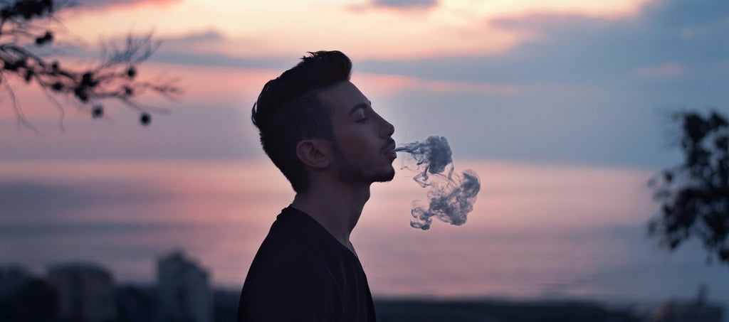 A person vaporizing outside.