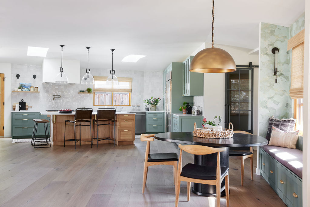 Image of a kitchen decorated with greens and bronze details.