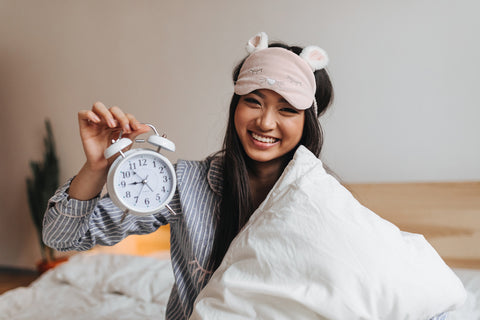 girl with analog alarm clock