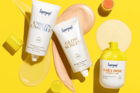 3 Supergoop sunscreens on a yellow background