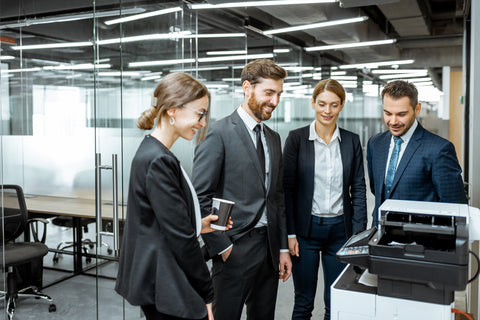 Team waiting for printer at the office | print needs | hybrid work | office printing