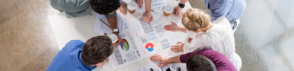 Team brainstorming at the office with printed presentation | coloured printing
