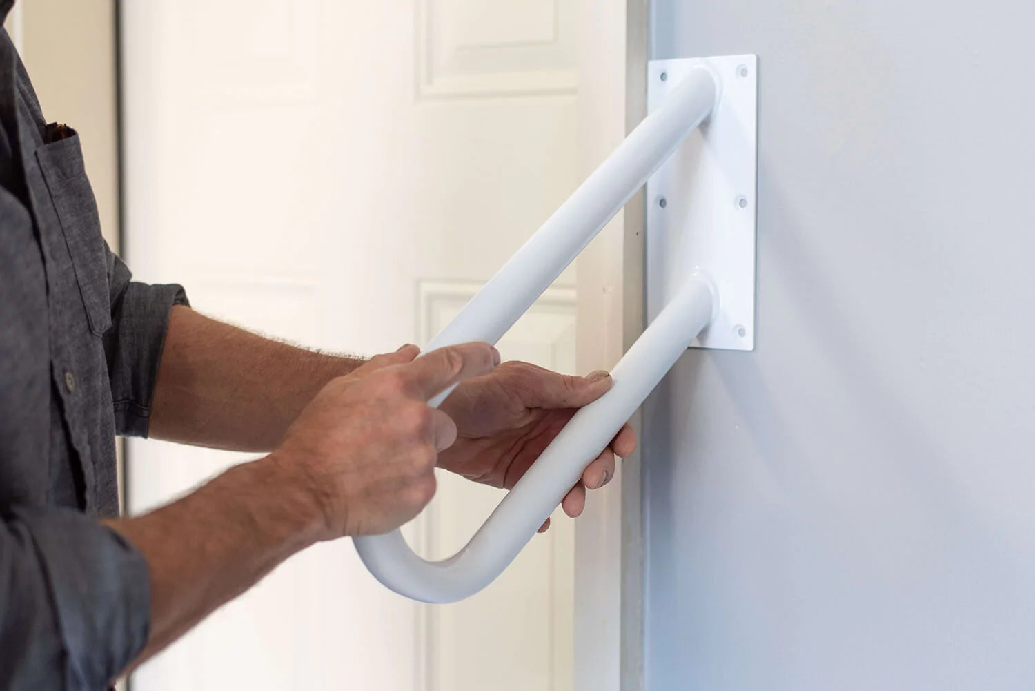 Man holding Wall Mount Handrail on wall