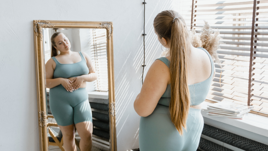 Une femme avec une longue queue de cheval se regarde dans le miroir