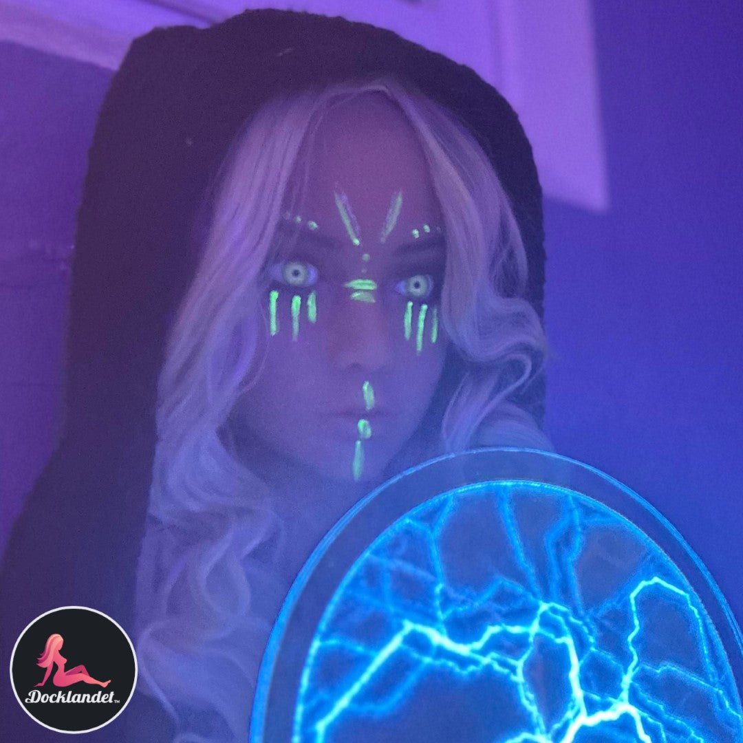 Sex doll at rave. Sex doll with UV make-up, white hair, black coat and blue led deco.