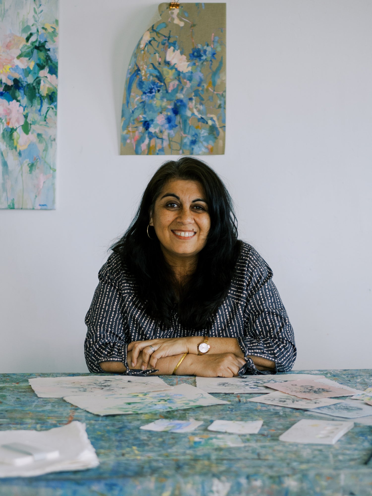 Step into Sonal Nathwani's world, where handmade paper serves as canvas for her vibrant floral and abstract paintings.