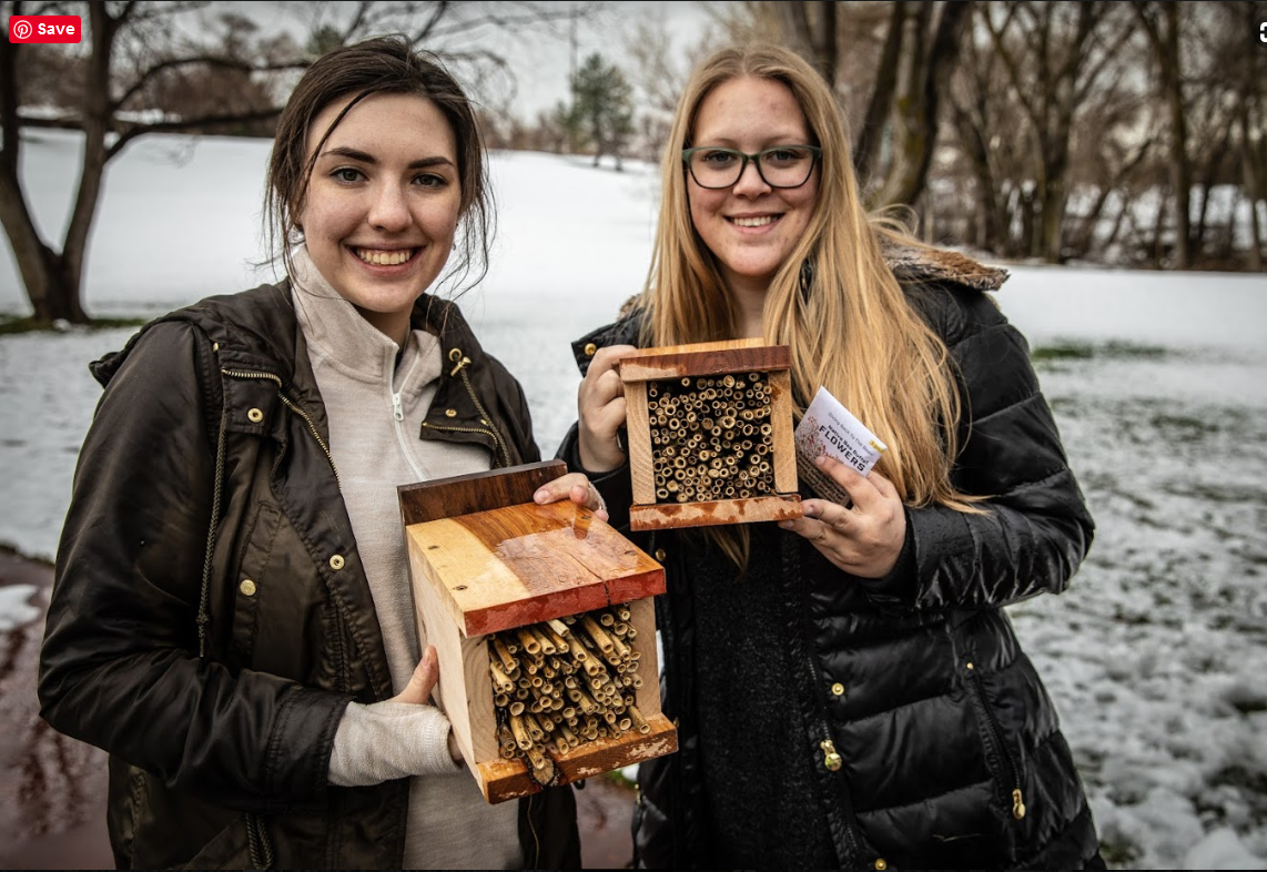 Women holding their completed Bee Habitat Boxes