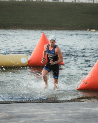 Endurance athlete racing out of the water
