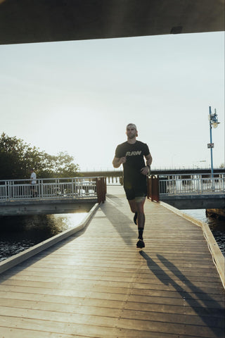 RAW endurance athlete running on a boardwalk