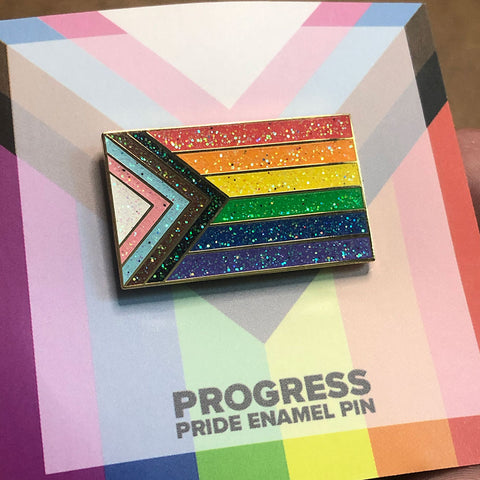 A rainbow pride flag pin with glitter in every color