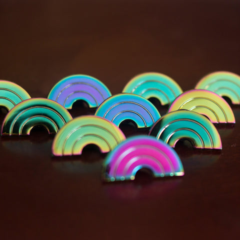 A bunch of rainbow enamel pins